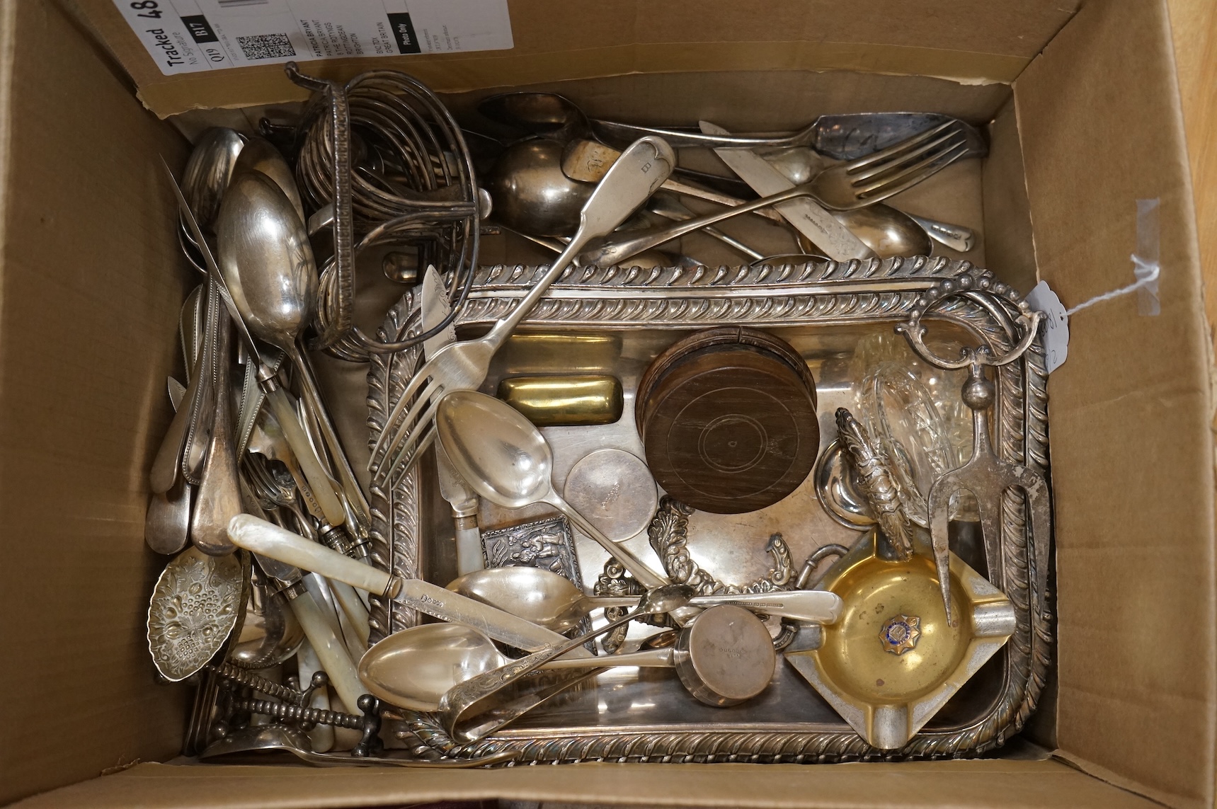 A group of assorted plated items including entree dishes, flatware and wine coaster.